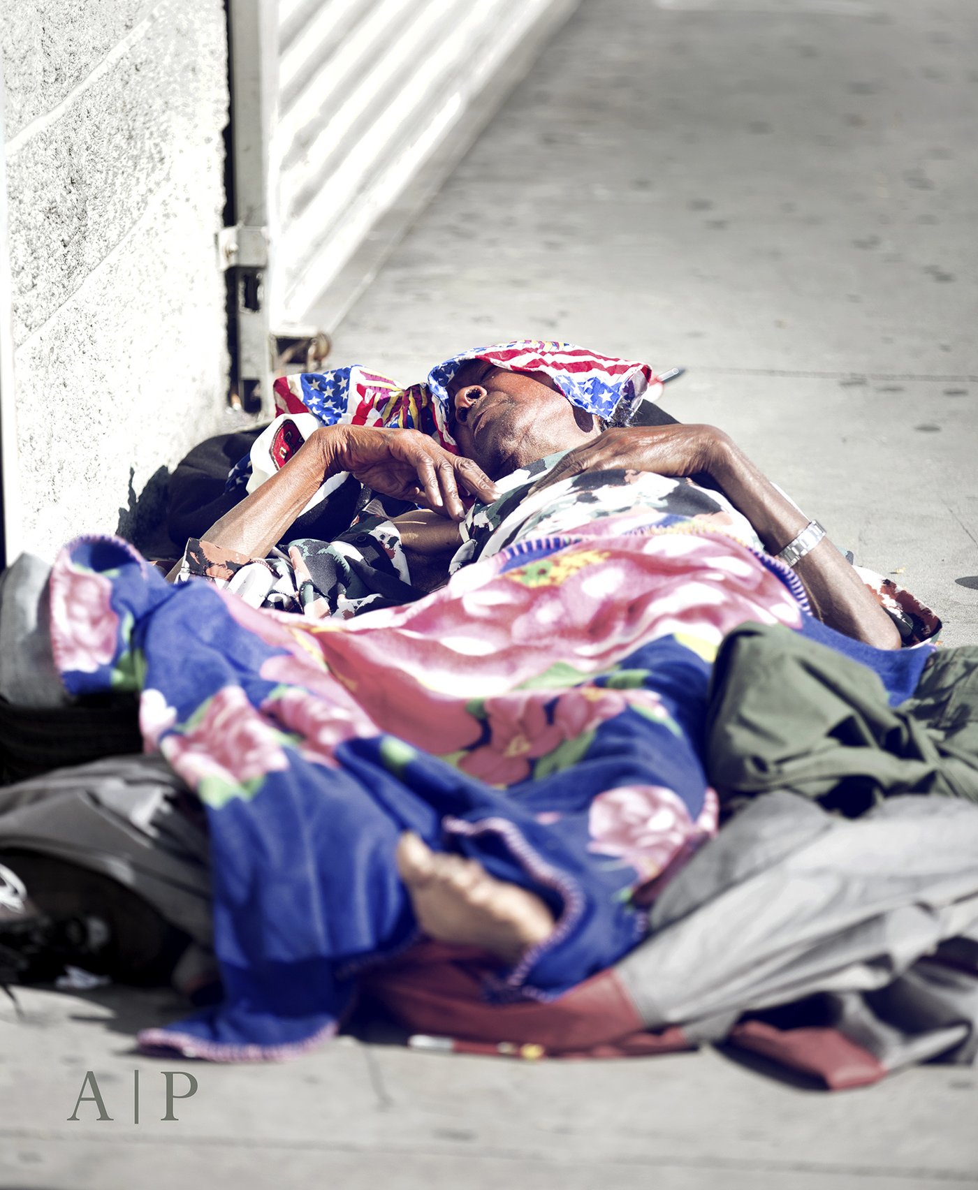 The Patriot — a man asleep on a downtown Los Angeles sidewalk, an American flag bandana folded across his brow